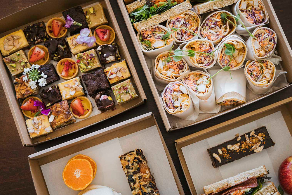 A mix of Arctic Kitchen catering platter options - small bites, sandwiches, wraps and slices