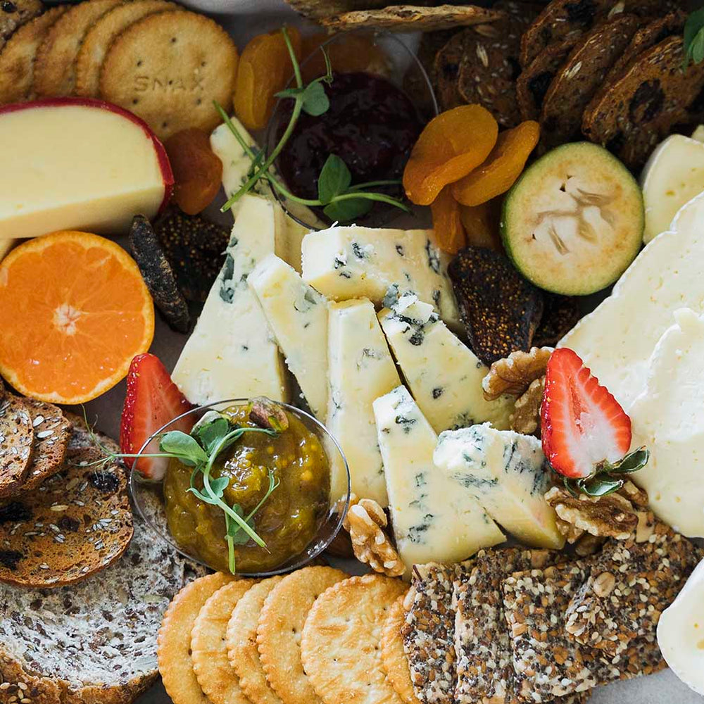Platter of artisan cheese, crackers and fruit