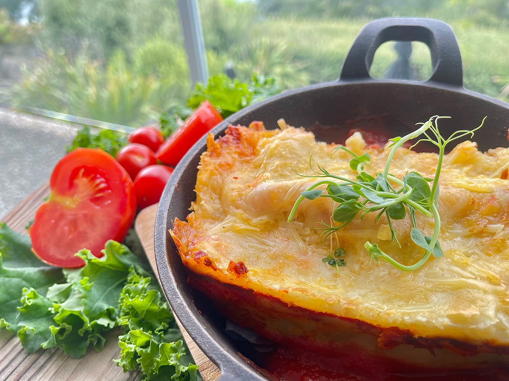 Cannelloni pasta filled with smoked chicken, ricotta, spinach, shaved parmesan on a classic tomato sauce