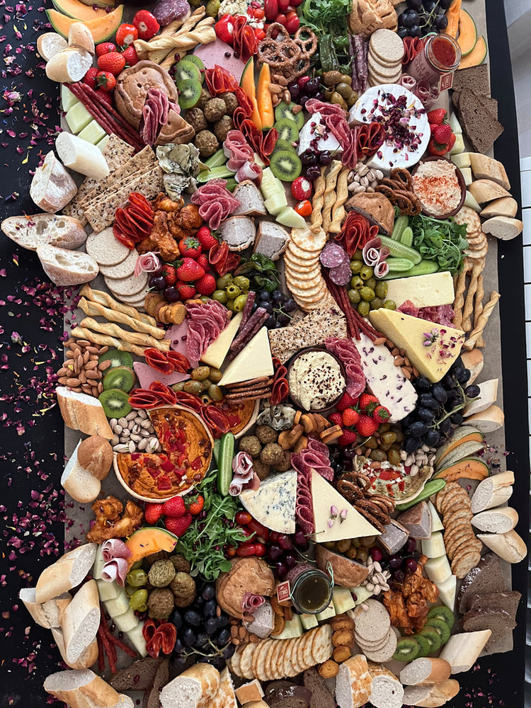 
                  
                    Grazing table full of local & imported artisan cheeses, cured meats, pickles, house made preserves & the freshest local produce.
                  
                