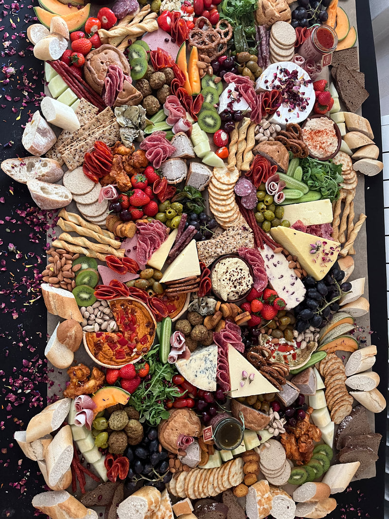 Grazing table full of local & imported artisan cheeses, cured meats, pickles, house made preserves & the freshest local produce.